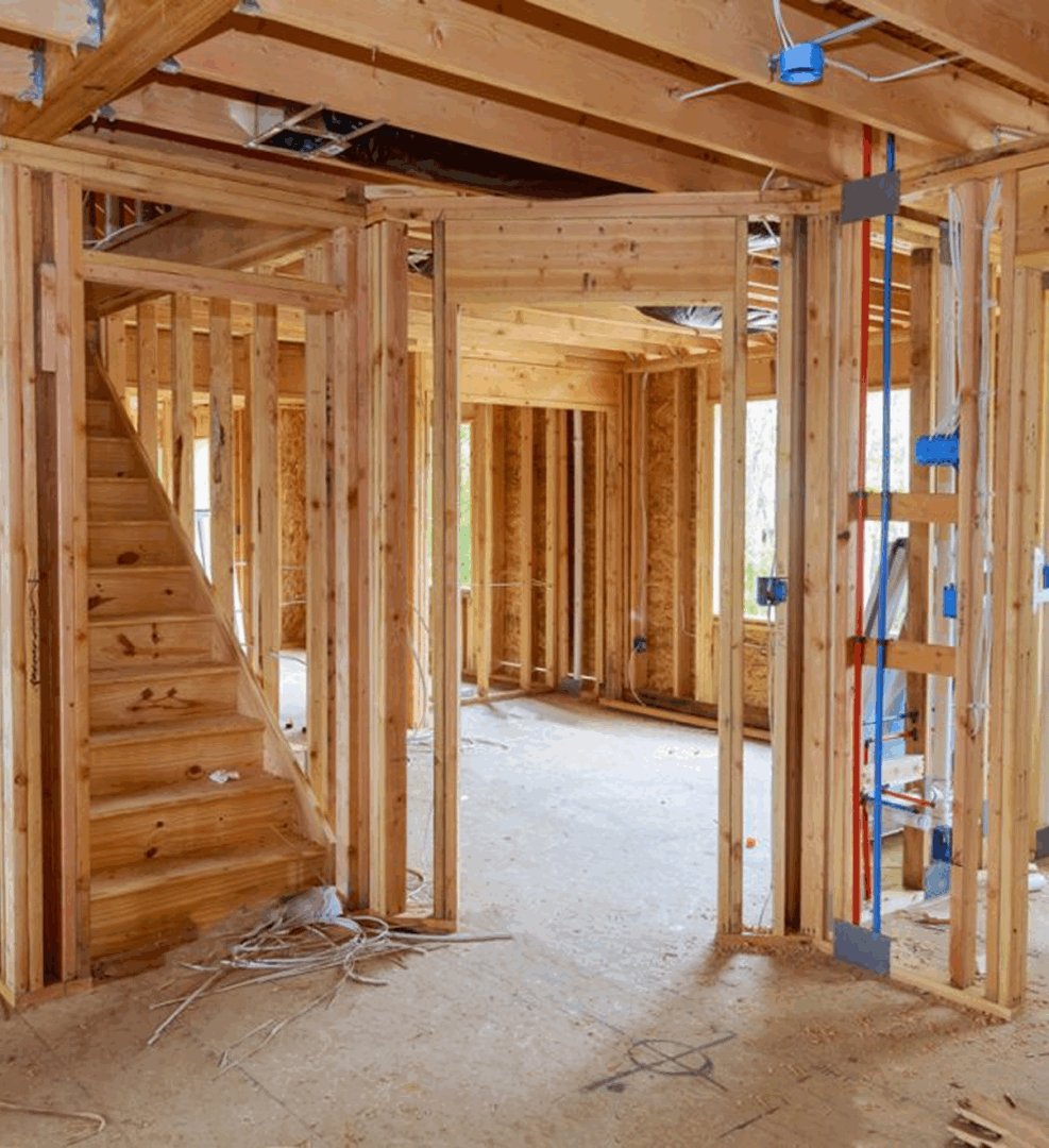 Unfinished wooden house interior under construction. Unfinished wooden house interior under construction.