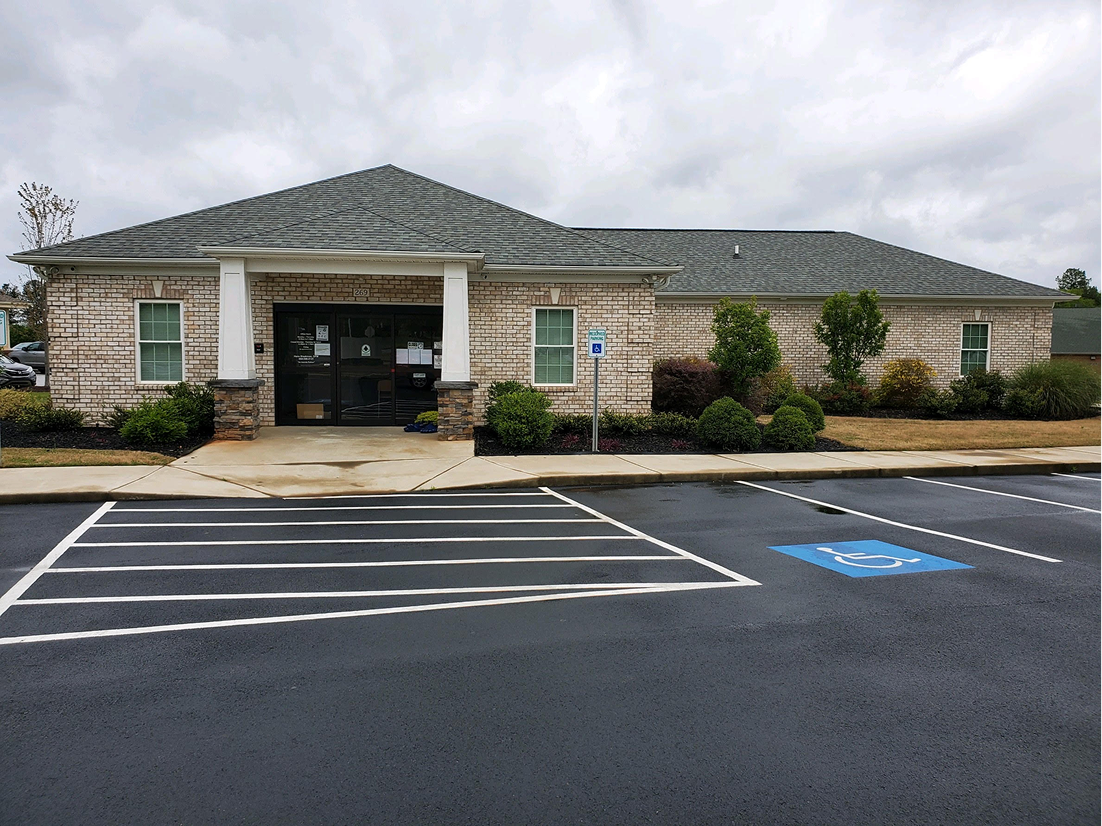 Single-story brick building with parking lot.