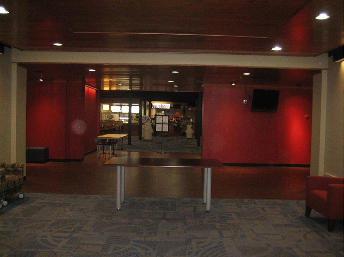 Empty lobby area with red walls.
